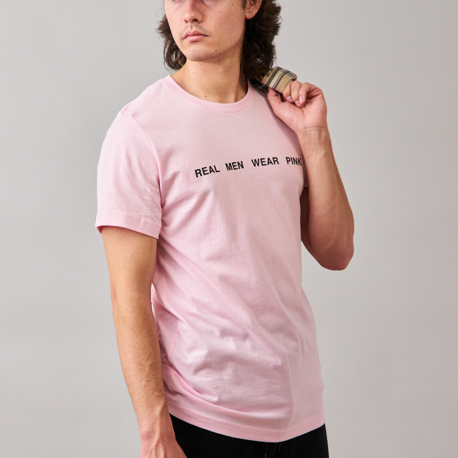 Man wearing a pink tshirt with 'REAL MEN WEAR PINK' printed on the front.