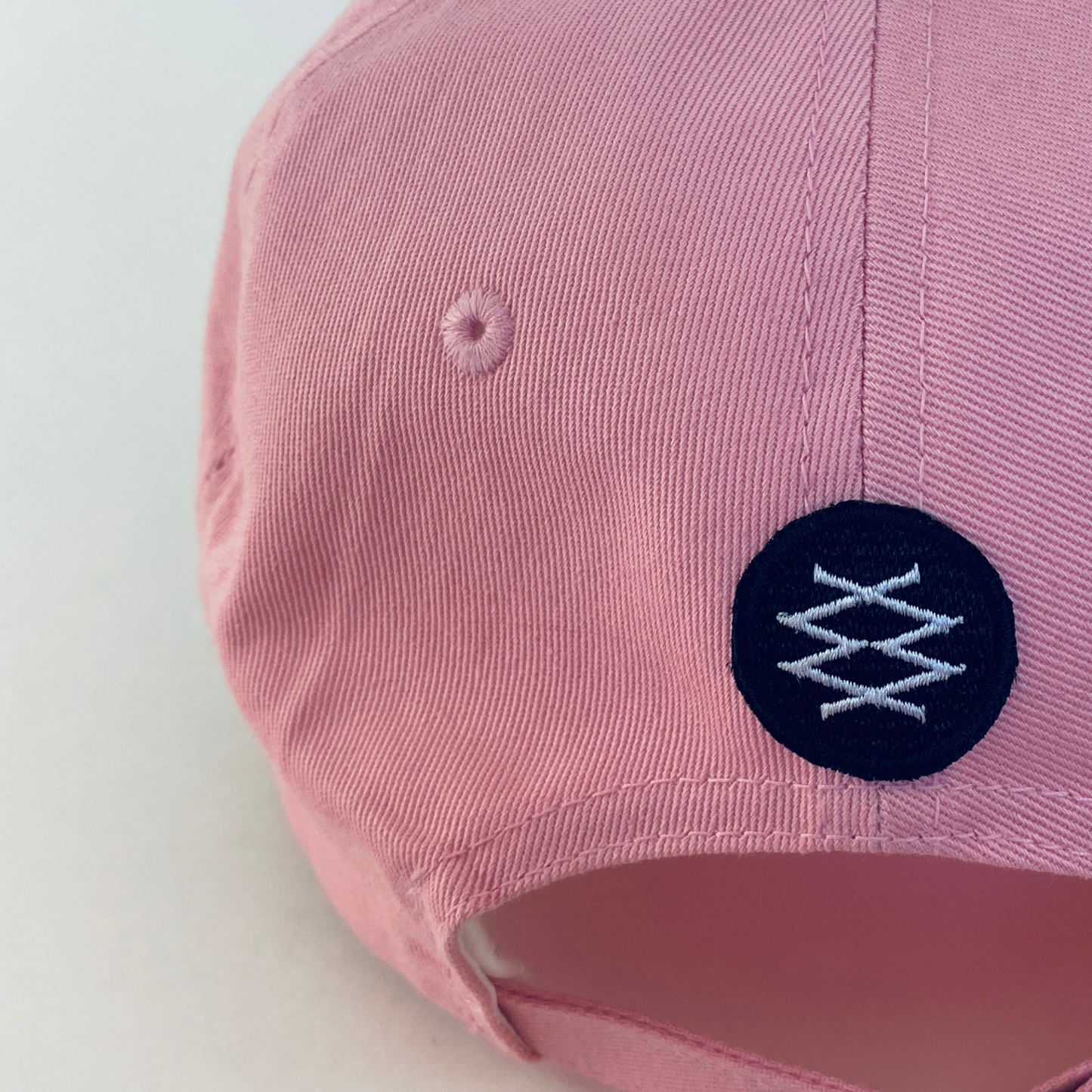 the back of pink dad cap showcasing the DUUW WUUD logo. 